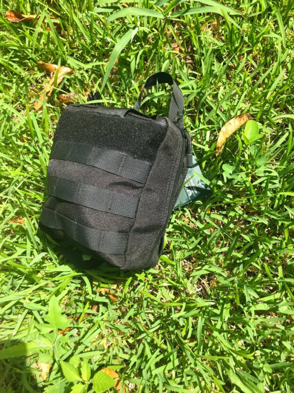 Hiking First Aid Kit Bundle lying on green grass.